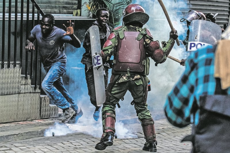 Police Officers Use Teargas And Clubs To Disperse