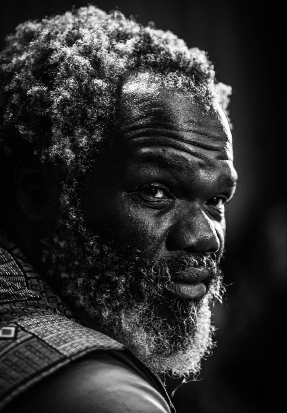 Une image de profil en gros plan en noir et blanc de Mbuso Khoza chantant dans un micro.