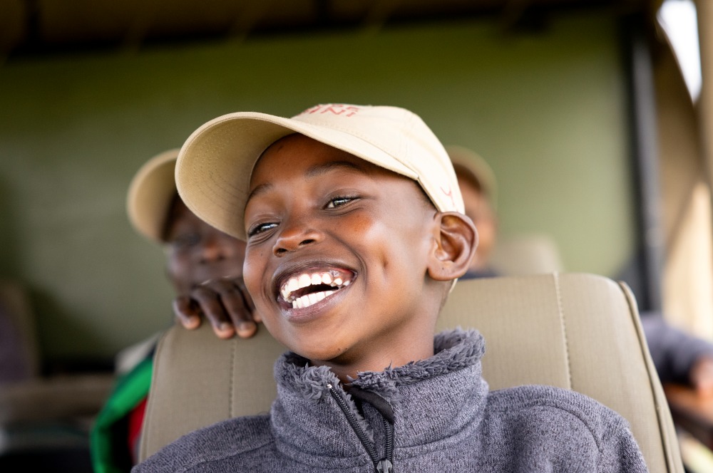Un enfant souriant d’enthousiasme à Twende Porini, au Kenya.