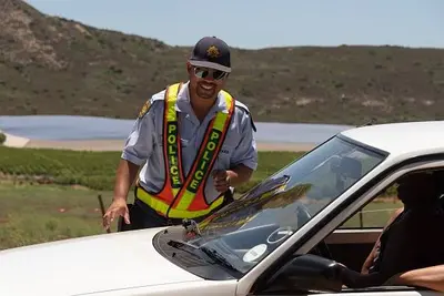 South African police officer on a roadside drivers license and insurance check. (Photo by Peter Titmus/UCG/Universal Images Group via Getty Images)