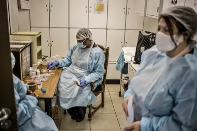 Nurses wearing personal protective equipment. (Photo by Marco Longari/AFP)